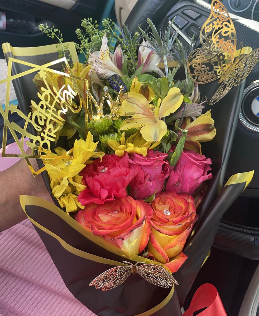 Bright mixed bouquet of roses, alstroemeria and carnations with a Happy Birthday topper