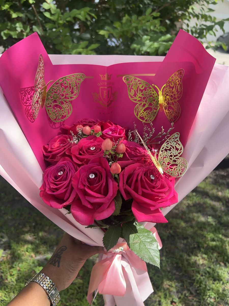 Hot pink roses with berries and gold butterflies in two-tone pink wrap