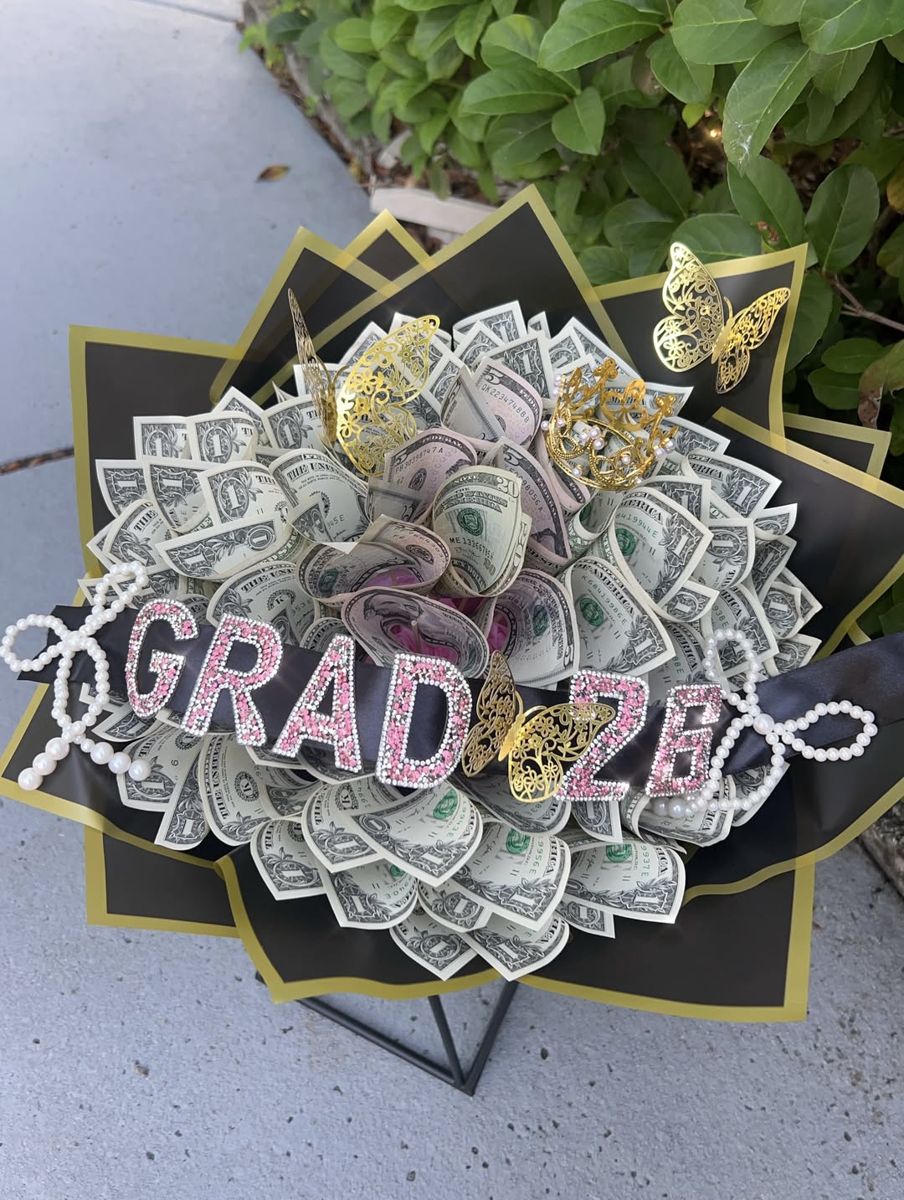 Money bouquet of folded bills with pink rhinestone GRAD 26 lettering and pearl bows